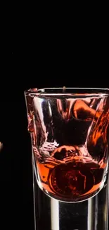 Elegant red glass against dark background wallpaper.