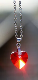 Red heart pendant on chain catches light beautifully.