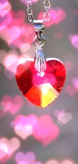 Shiny red heart pendant on blurred railway background.