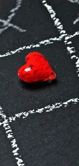 Red glass heart on black chalkboard background, perfect for phones.