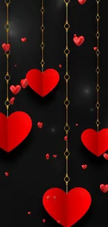 Mobile wallpaper with red hearts on golden chains on a black background.