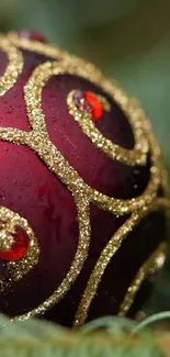 Elegant red ornament with gold swirls on a festive background.