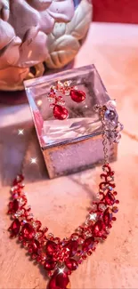 Elegant display of red necklace and earrings on a decorative background.