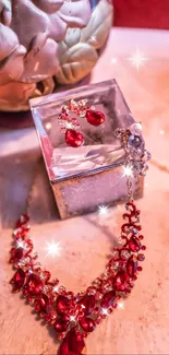 Elegant red necklace and earrings on display in a decorative setting.