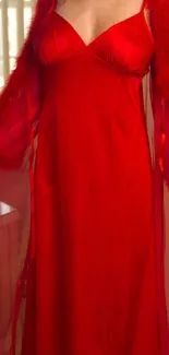 Elegant woman in red night gown, standing gracefully.