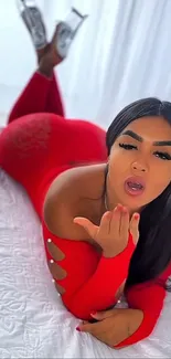 Woman in red outfit lying on bed
