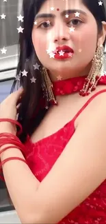 Woman in elegant red outfit with star effects.