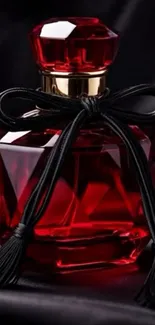 Elegant red perfume bottle with black ribbon.
