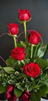 Vibrant red roses with green leaves in a romantic bouquet.