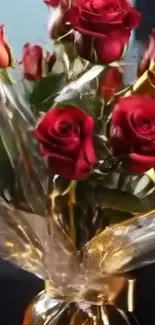 Elegant bouquet of red roses wrapped in golden foil.
