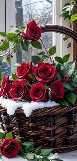 Red roses in a basket with green leaves and winter accents.