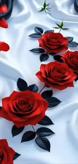 Elegant red roses on silky white fabric wallpaper.