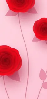 Three red roses on soft pink wallpaper background.