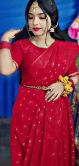 Woman in an elegant red saree with jewelry