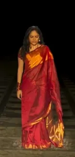 Woman in red saree on railway track wallpaper.