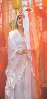 Lady in a white dress behind red veils with lanterns.