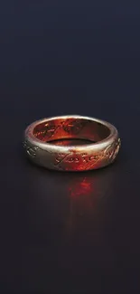 Golden ring on dark blue background with red glow.