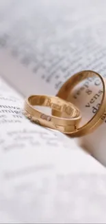 Gold rings on an open book page.