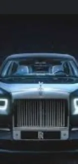 Sleek Rolls-Royce ghost car in a dark elegant setting.