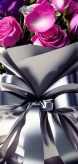 Elegant bouquet of pink and purple roses wrapped in silver ribbon.