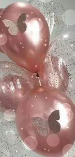 Rose gold balloons with butterflies and glitter confetti.