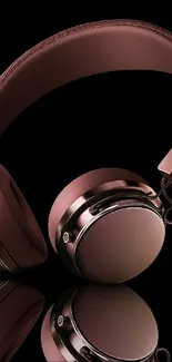 Rose gold headphones against a sleek black background.