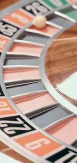 Close-up shot of a roulette wheel with a ball resting on the numbers.