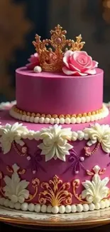 Elegant pink cake with floral decorations and a royal crown topper.