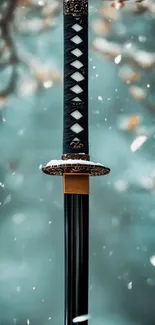 Samurai sword with elegant hilt amidst falling snow.