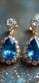 Close-up of elegant sapphire earrings with diamond accents.