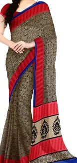 Beautiful saree with bold patterns in bright red and blue accents.