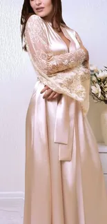 Elegant satin and lace gown with floral accents in a soft cream color.