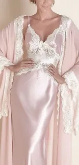 Elegant satin lingerie with lace in pastel pink.