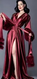 Model in a luxurious deep red satin robe showcasing elegance.