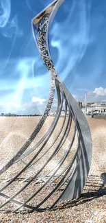 Beach with a metal sculpture under a clear blue sky.