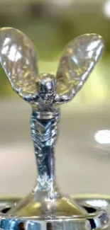 Silver car ornament with wings in a luxury design.