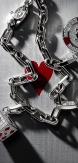 Silver chain with playing cards motif and red heart design.