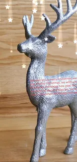 Silver deer sculpture on a wooden background, perfect for mobile wallpaper.