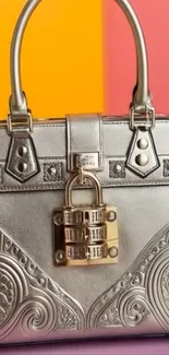 Silver designer handbag with padlock on vibrant background.