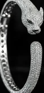 Diamond-encrusted panther bracelet on dark background.