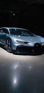 Silver supercar in dimly lit showroom showcasing sleek design.