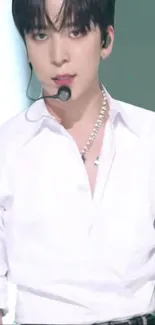 Mobile wallpaper of singer wearing stylish white shirt on stage.