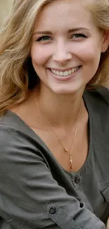 Smiling woman in an olive green shirt, outdoors.