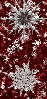 Intricate silver snowflakes on a crimson background wallpaper.