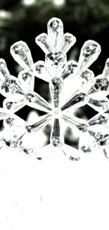 Intricate snowflake design on snowy background wallpaper.