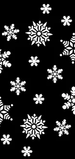 Intricate white snowflakes on black background wallpaper