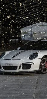 White sports car beneath sparkling lights in a modern setting.