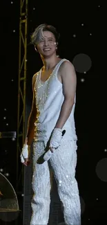 Elegant performance on stage with a sparkling white costume and dark background.