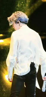 Stage performer in elegant white shirt with dynamic background.