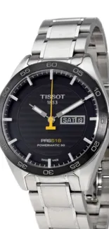 Silver Tissot watch with black dial and day-date display.